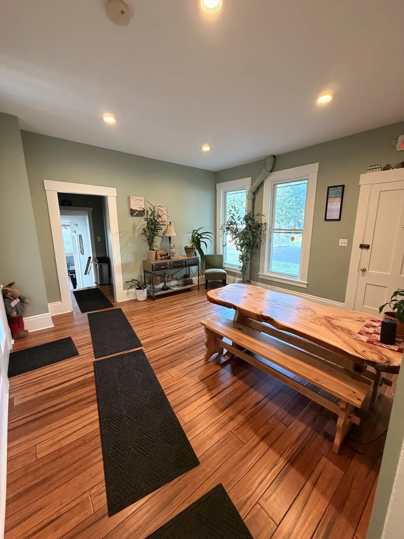 Second view of the dining room with a table and warm wood floors at the Concord, NH office