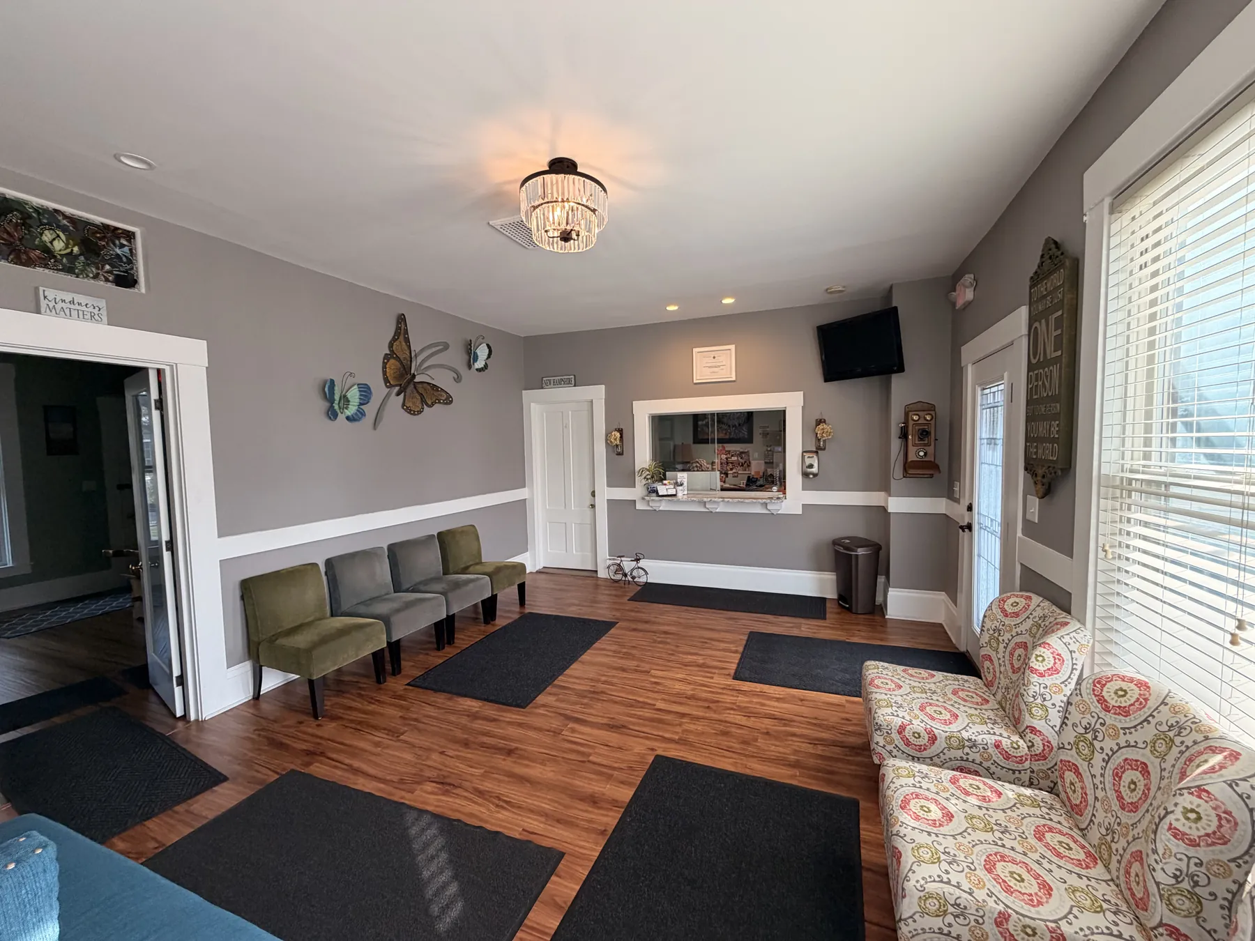 Waiting room lobby with reception window, seating, and entry door at the Concord, NH office