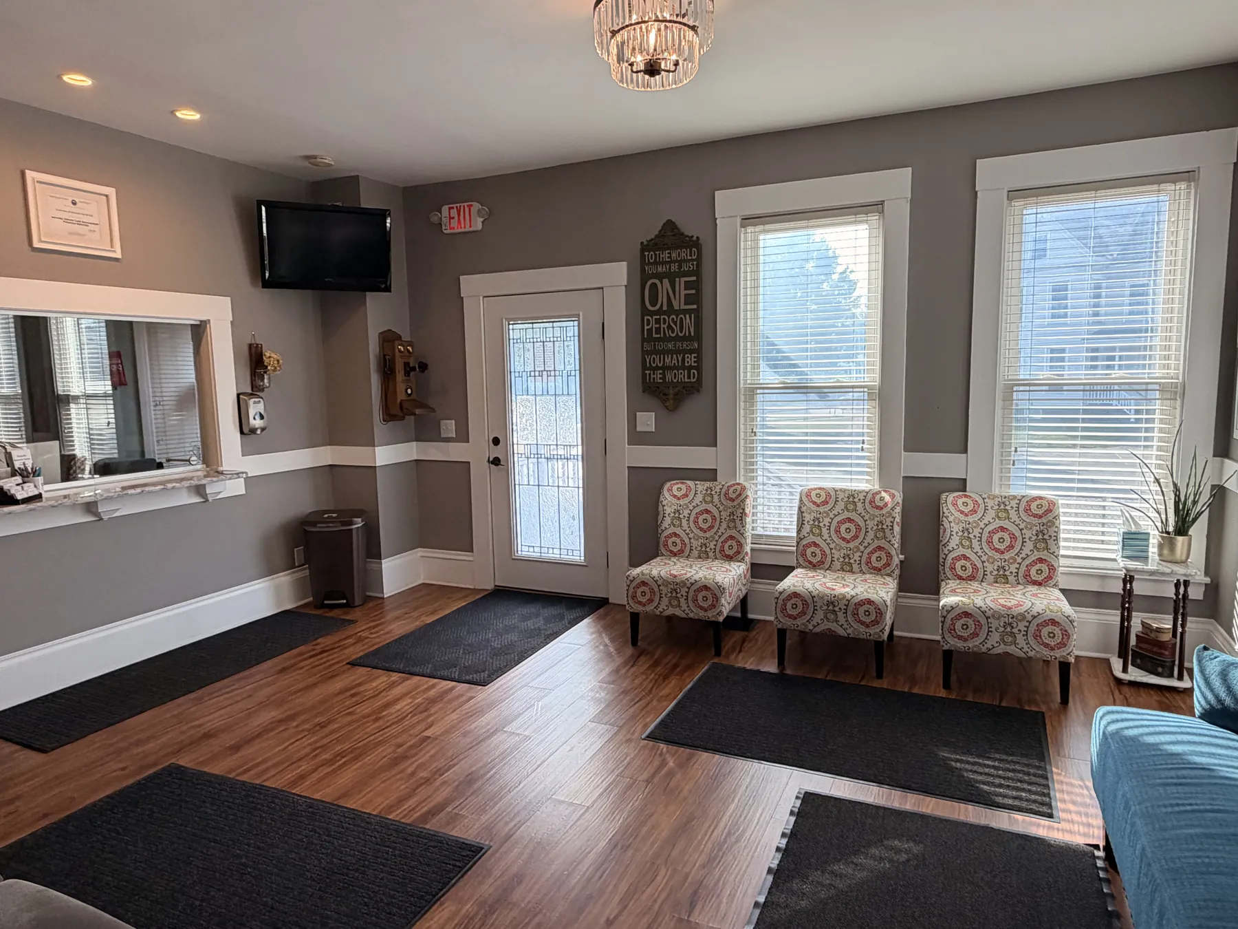 Waiting room lobby with entry door, windows, and visitor seating at the Concord, NH office
