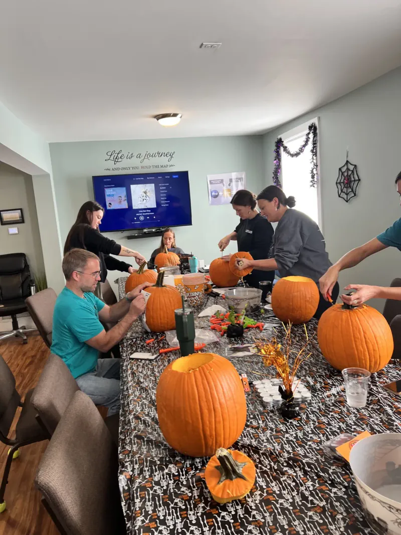 Chrysalis Recovery Center team carving pumpkins in 2025