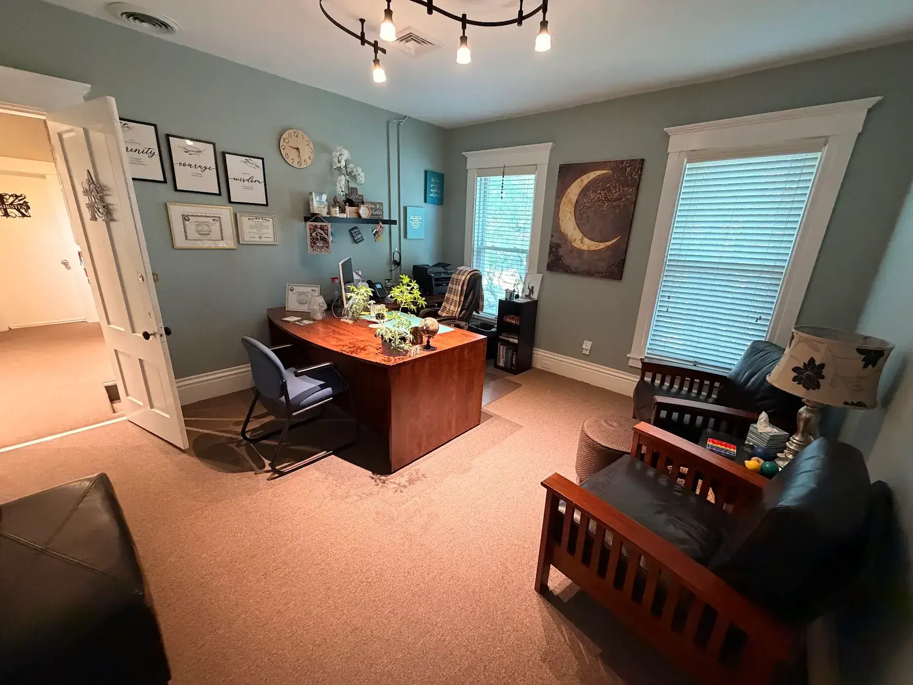 Alyse’s office with a desk, windows, and warm wood furniture at the Concord, NH office