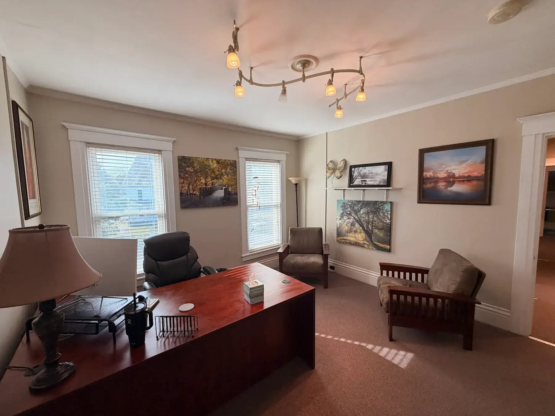 Courtney’s office with a desk, chairs, and framed artwork at the Concord, NH office