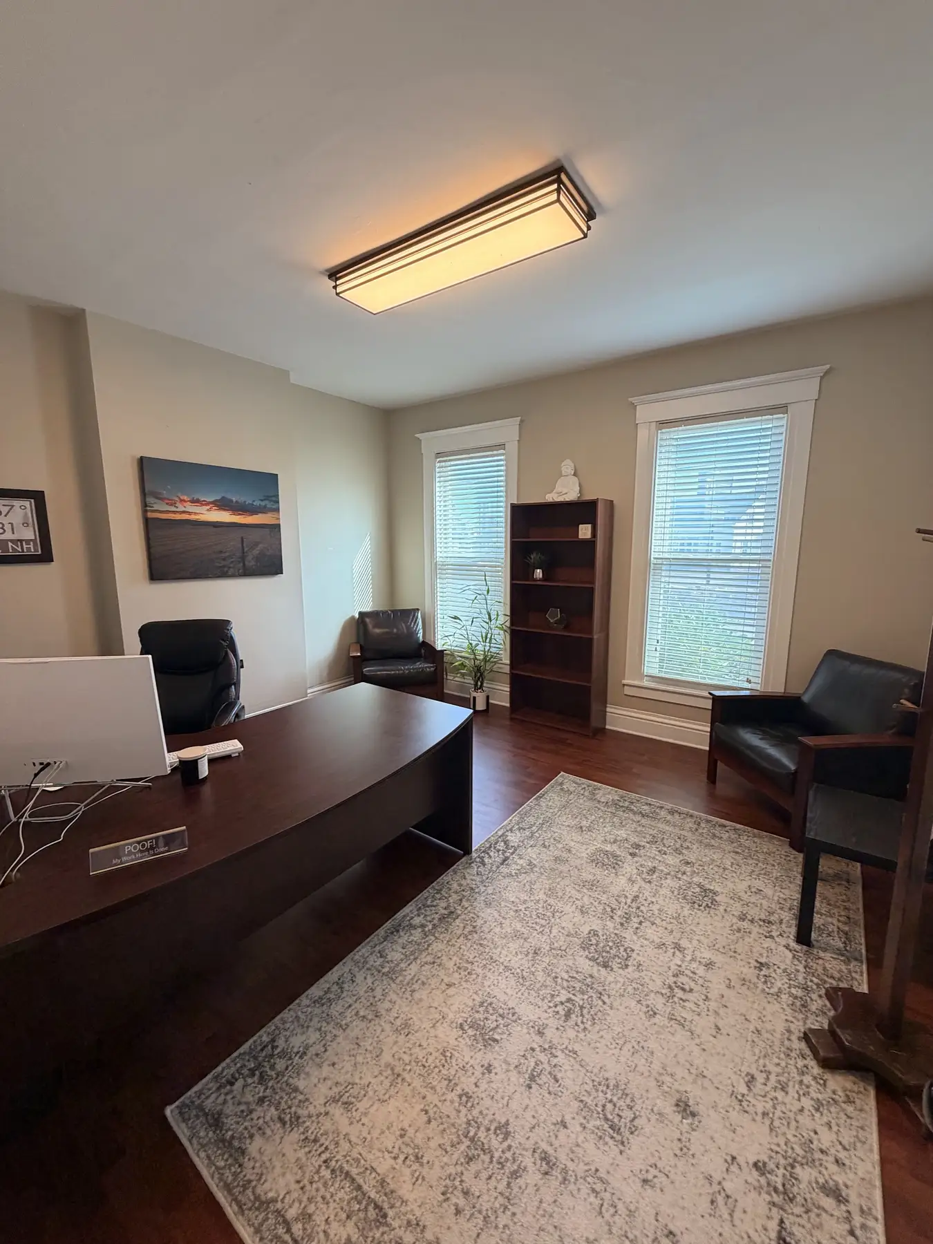 Second view of the intake office with a desk and windows at the Concord, NH office