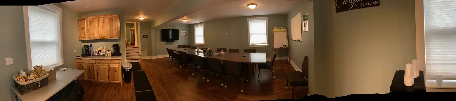 Wide conference room with a long table and chairs at the Concord, NH office