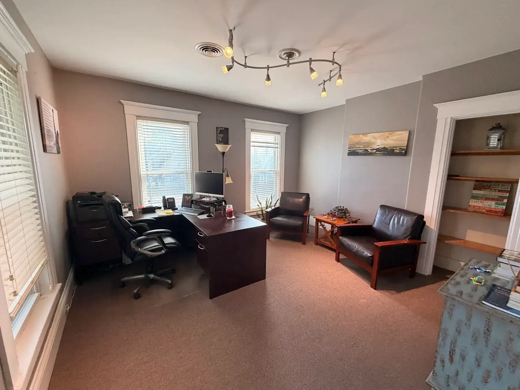 Mike’s office with a desk, computer, and lounge chair at the Concord, NH office