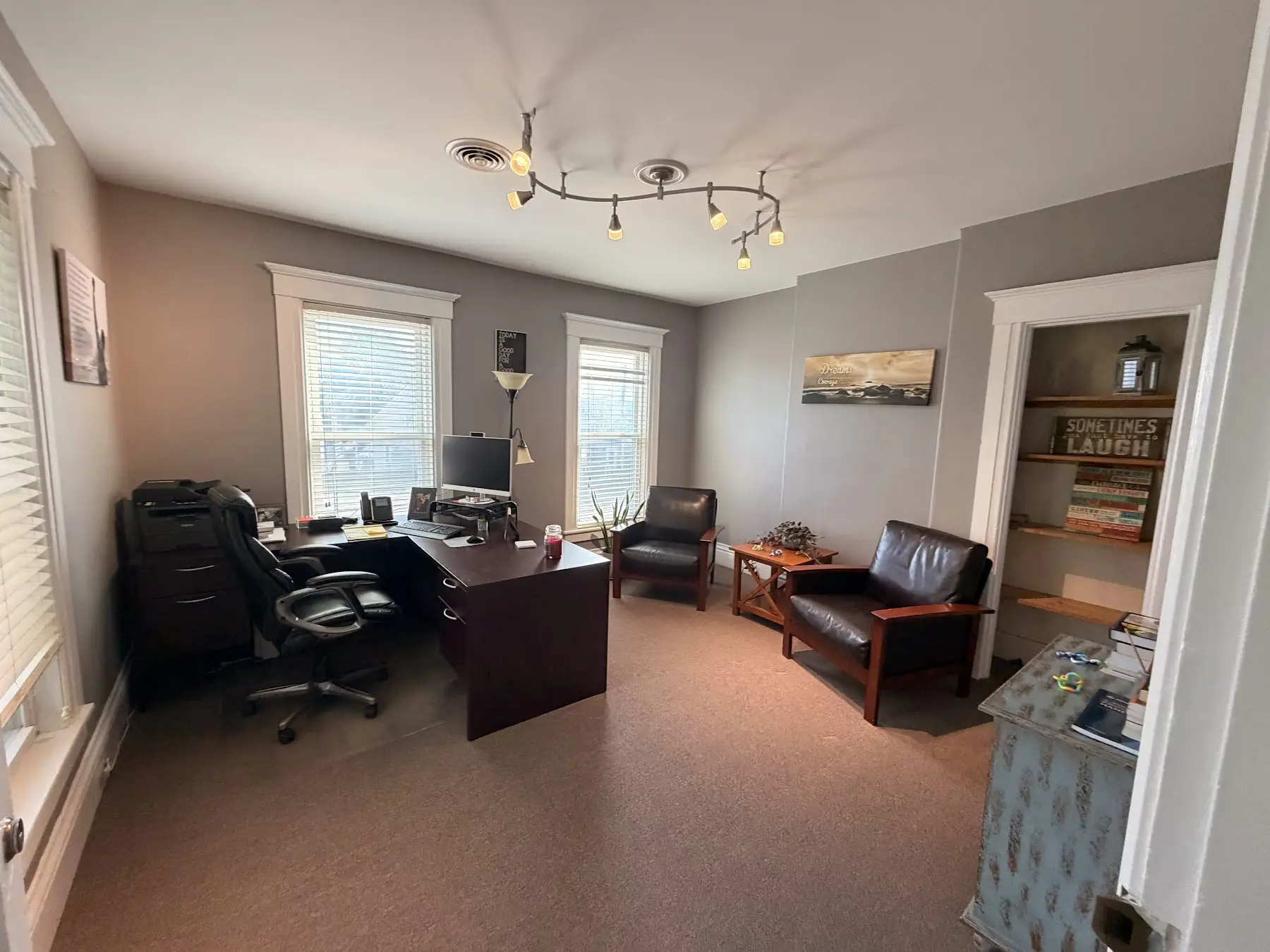 Second view of Mike’s office with a desk and seating at the Concord, NH office