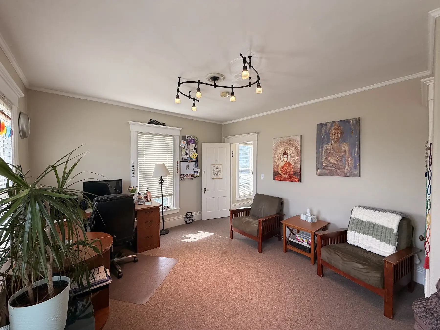 Third view of Sarah’s office with seating and artwork at the Concord, NH office
