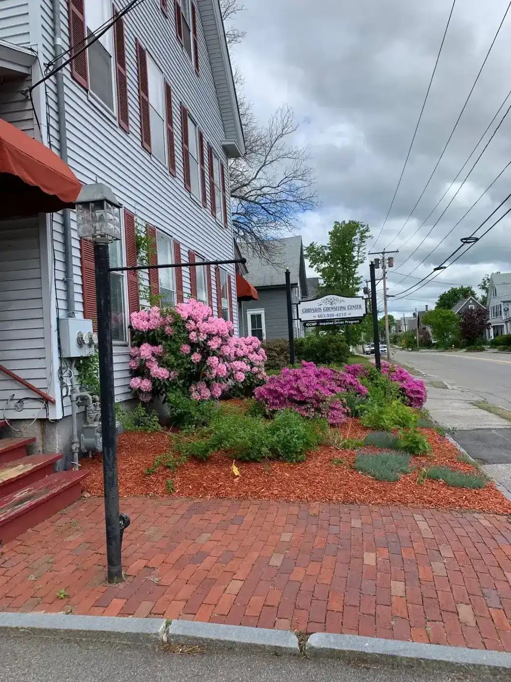 Road view of the Chrysalis Recovery Center building and sign in Concord, NH